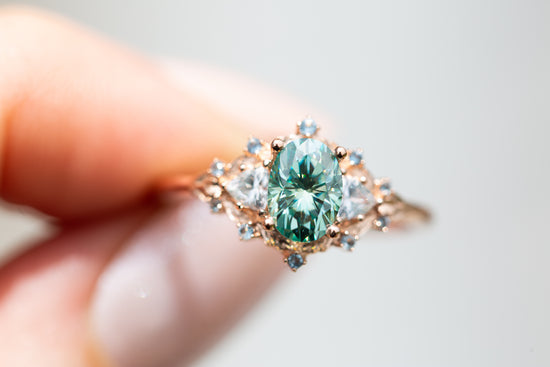 Woodland three stone with teal moissanite and aqua accents