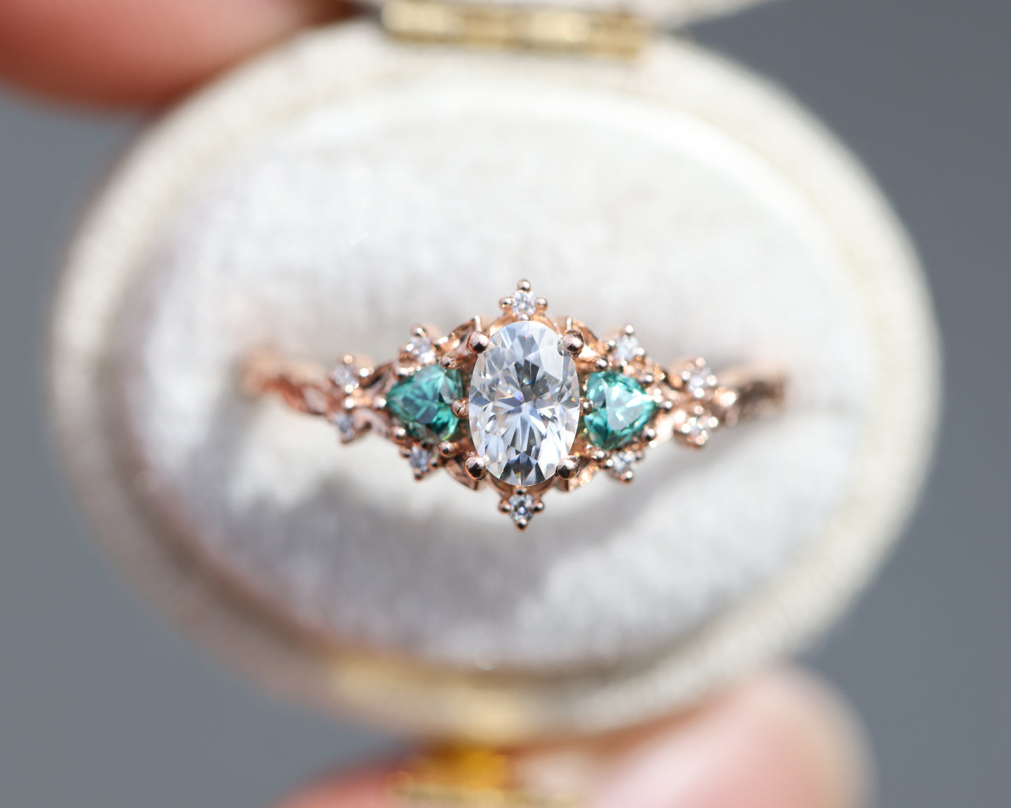 Briar rose three stone with oval moissanite and teal moissanite side stones