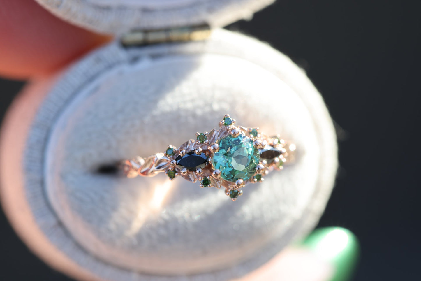 Briar rose three stone with round lab green sapphire and black diamond sides and accents