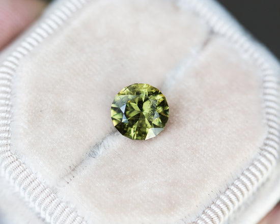 2.6ct round olive green salt and pepper sapphire