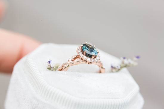 Oval blue green sapphire halo twist leaf ring