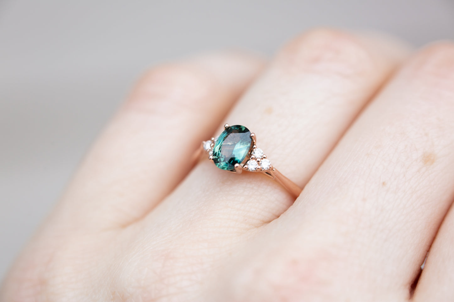 Oval teal sapphire cluster open work ring