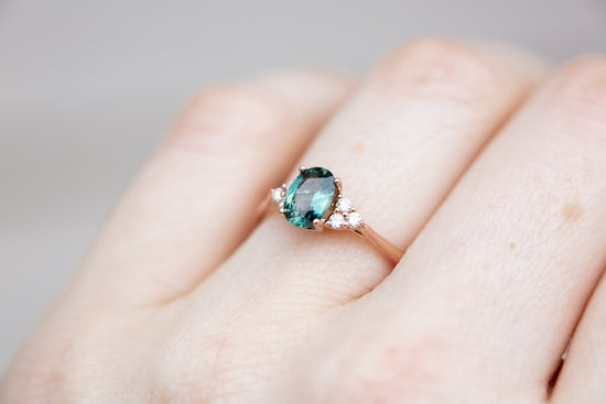 Oval teal sapphire cluster open work ring