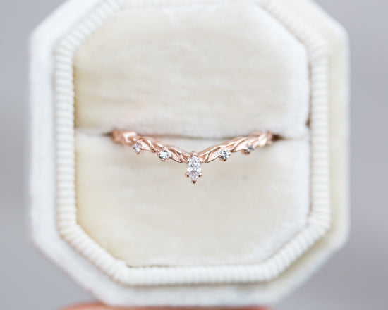 Curved leaf wedding band with marquise diamond
