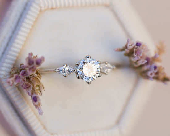 Three stone ring with 5mm round moissanite and marquise side stones