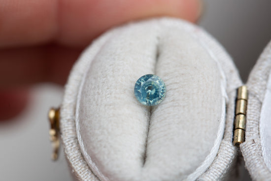 Load image into Gallery viewer, .56ct round opalescent teal sapphire
