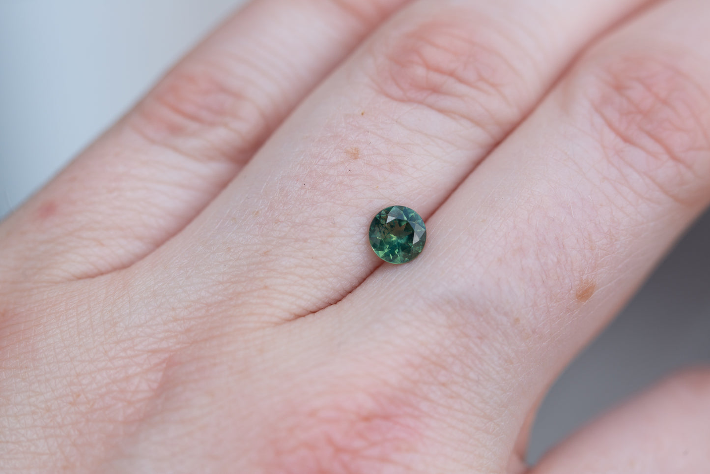 .75ct round teal green sapphire