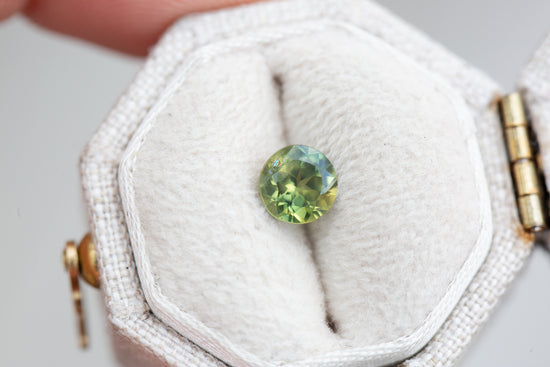 .83ct round green with a little yellow sapphire