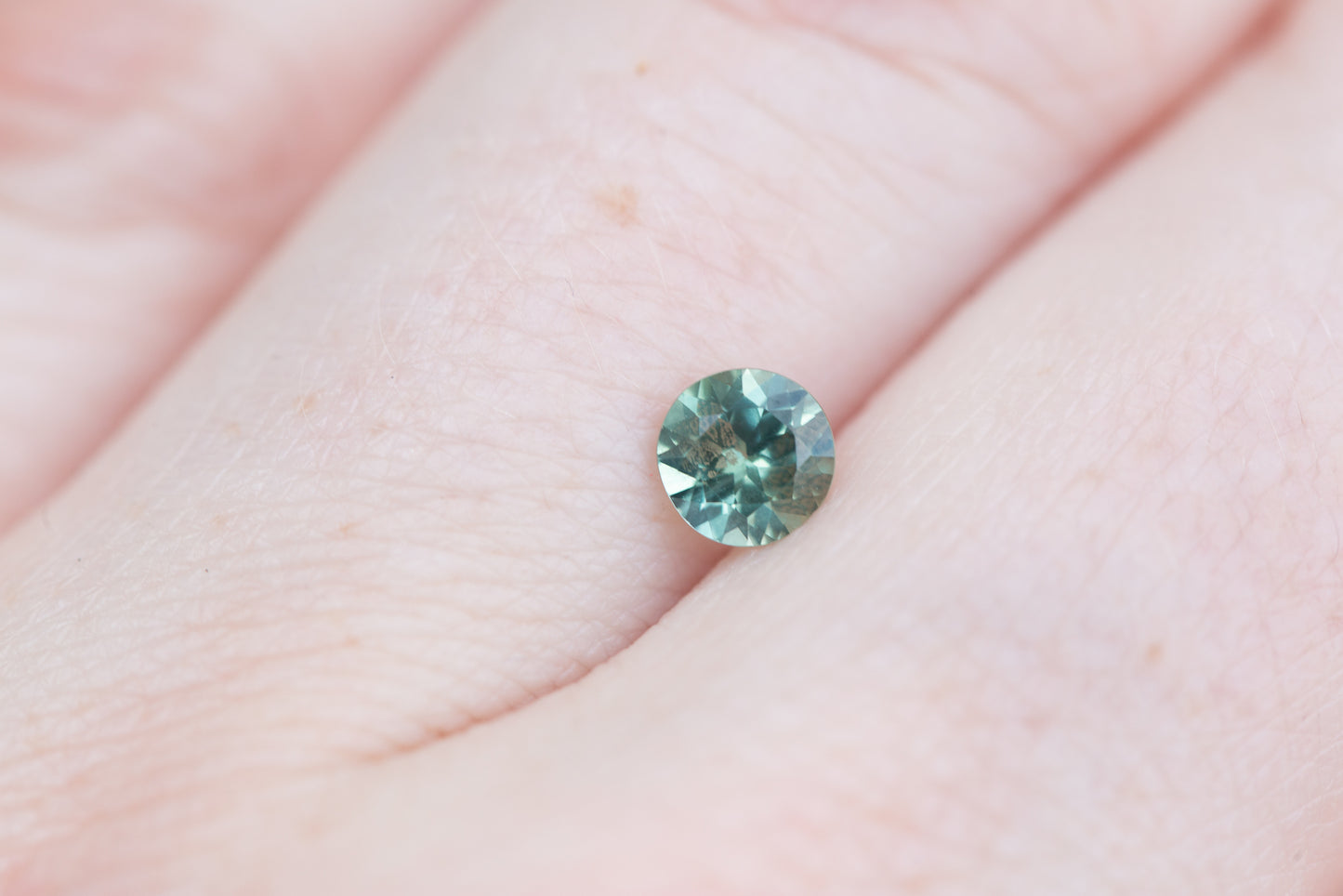.63ct round teal sapphire