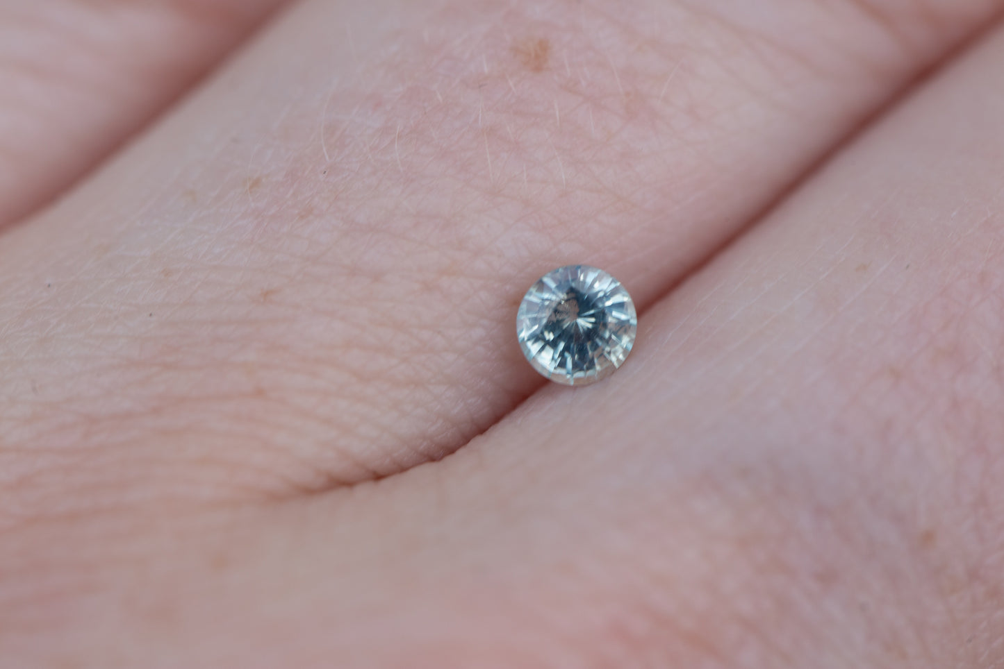 .375ct round opalescent icy blue sapphire