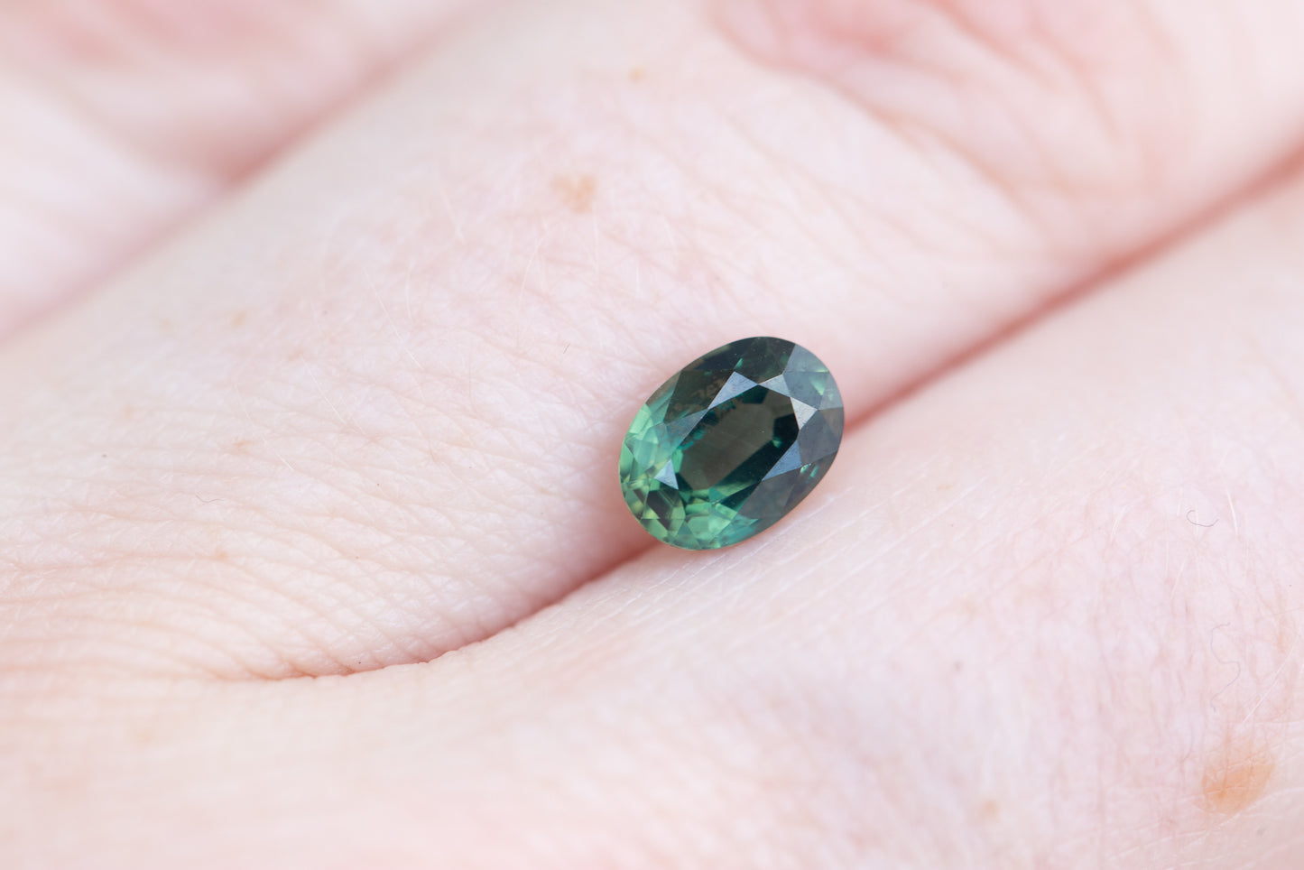 1.1ct oval deep green hint of blue sapphire