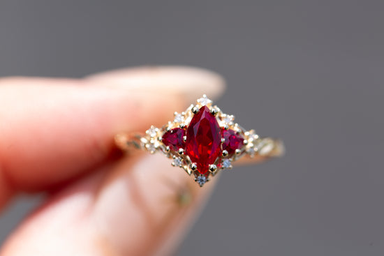 Briar rose three stone with marquise lab ruby center and lab ruby sides
