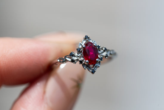 Briar rose halo with oval lab ruby and black diamonds