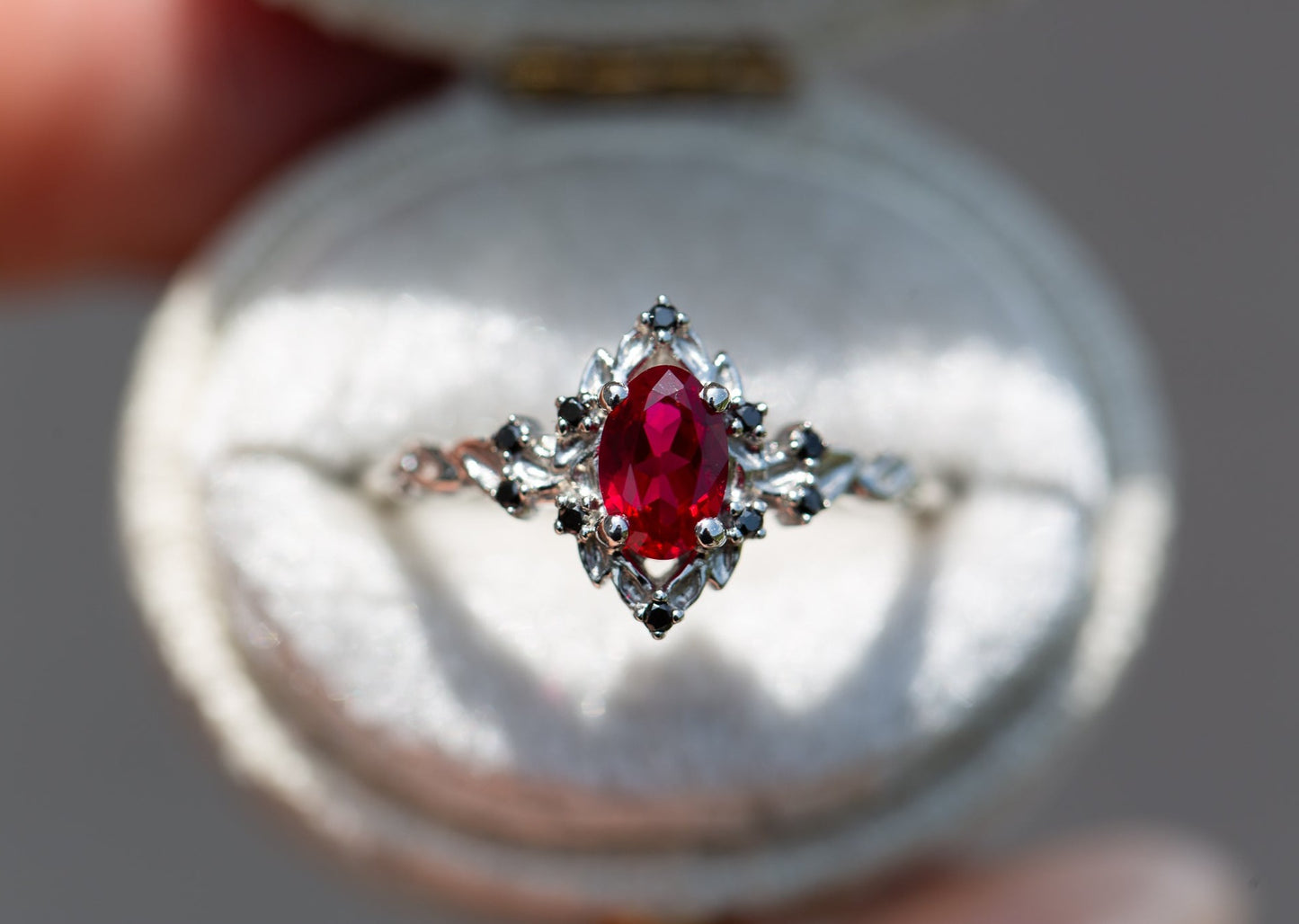 Briar rose halo with oval lab ruby and black diamonds