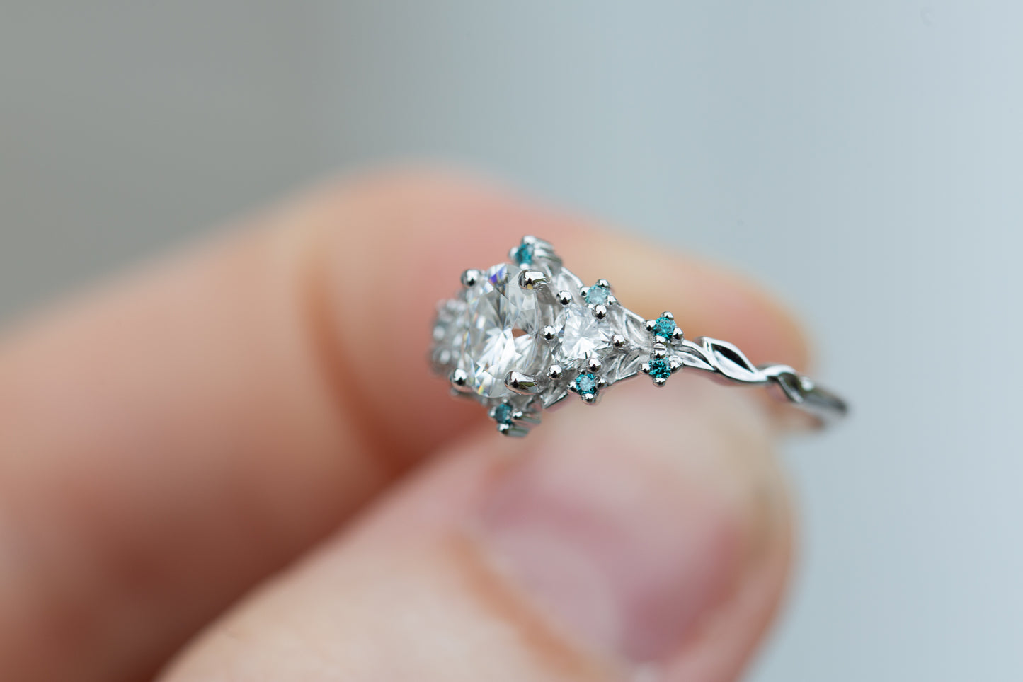 Briar rose three stone with moissanite and blue teal irradiated diamond accents