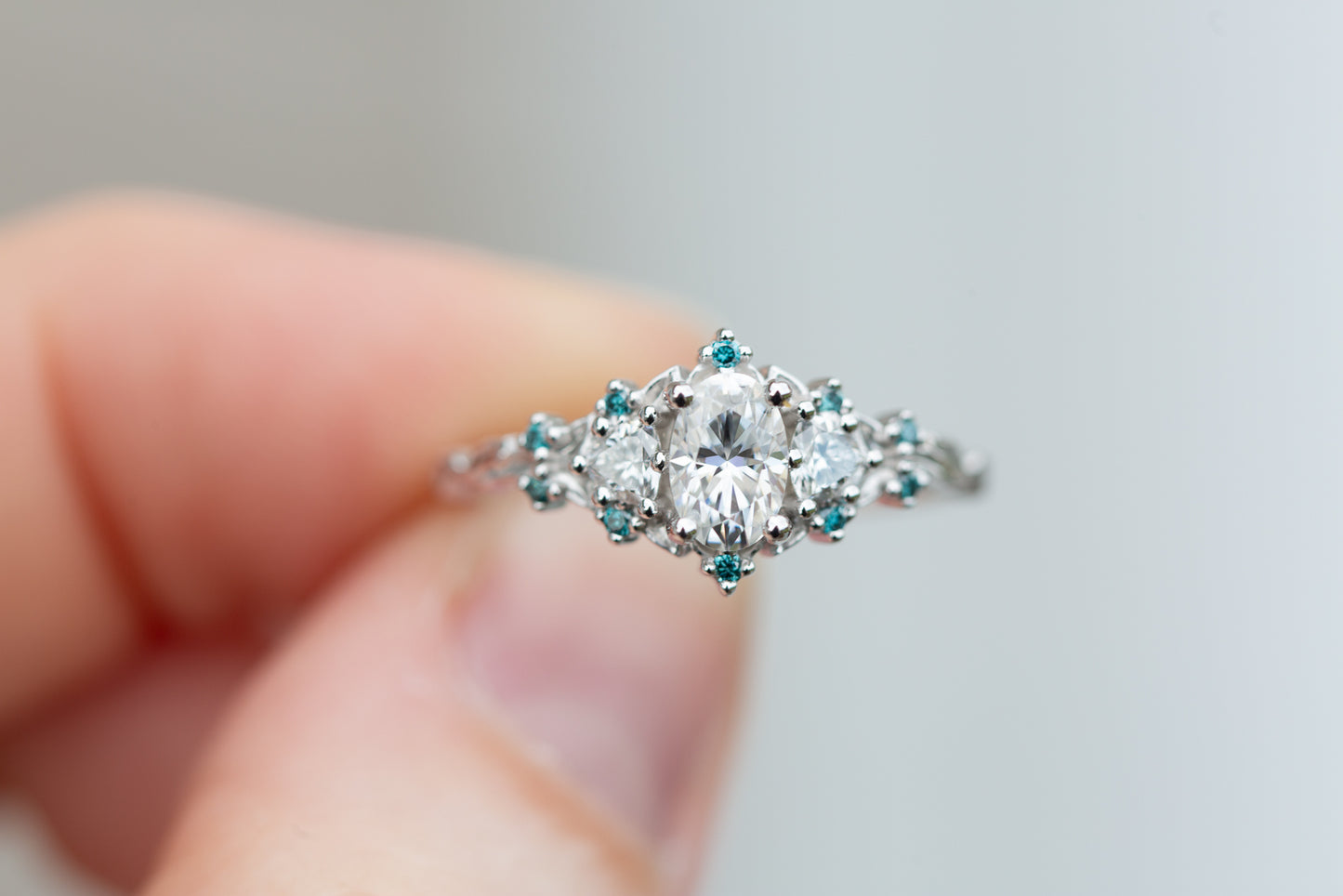 Briar rose three stone with moissanite and blue teal irradiated diamond accents