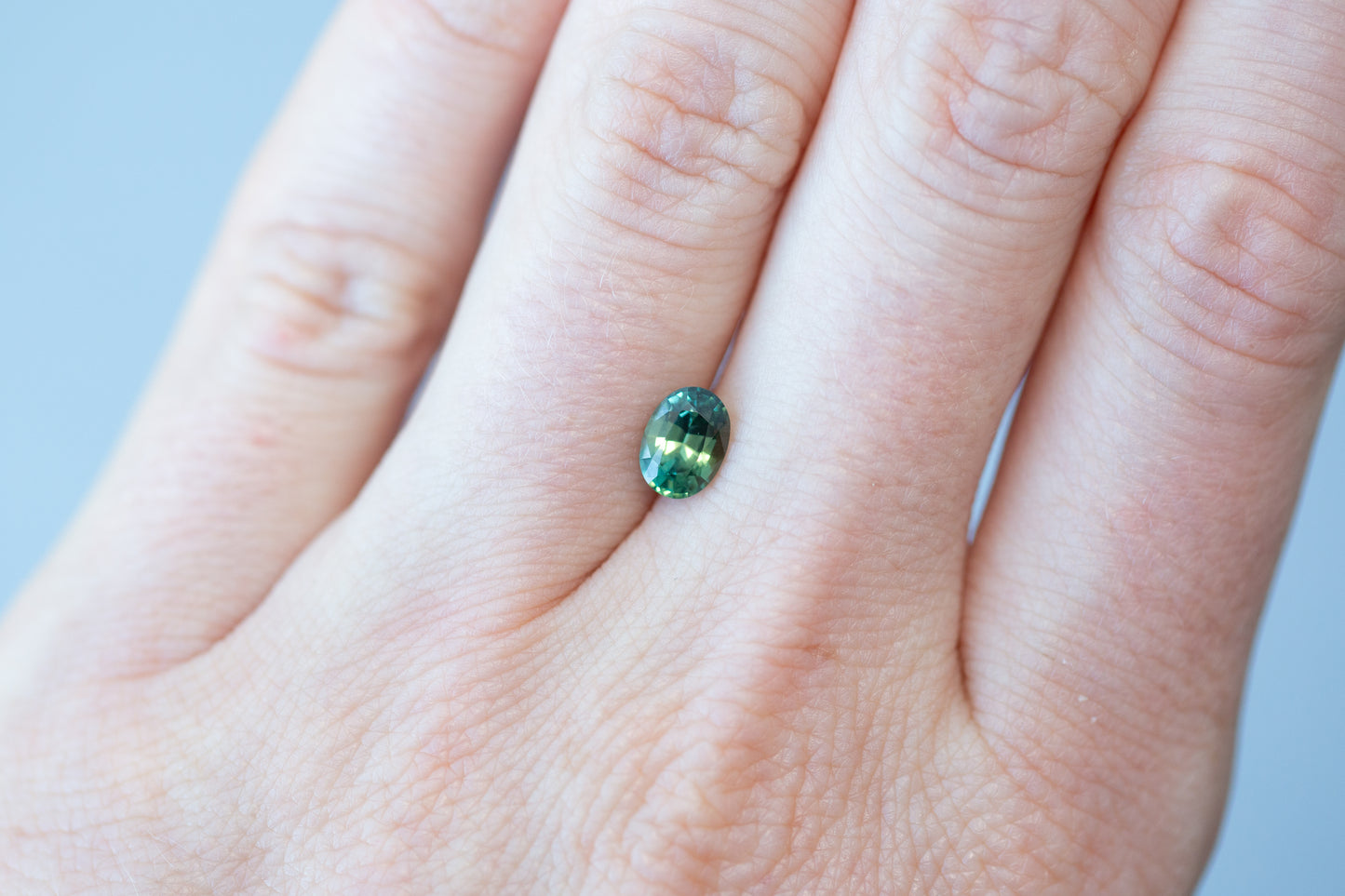 1.02ct Oval Yellowish Green Teal Sapphire