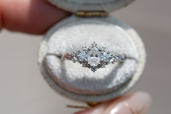 Load image into Gallery viewer, Briar rose three stone with oval moissanite center and round moissanite sides
