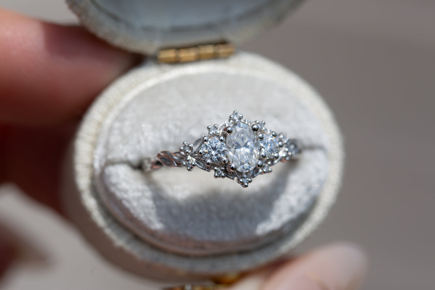 Load image into Gallery viewer, Briar rose three stone with oval moissanite center and round moissanite sides
