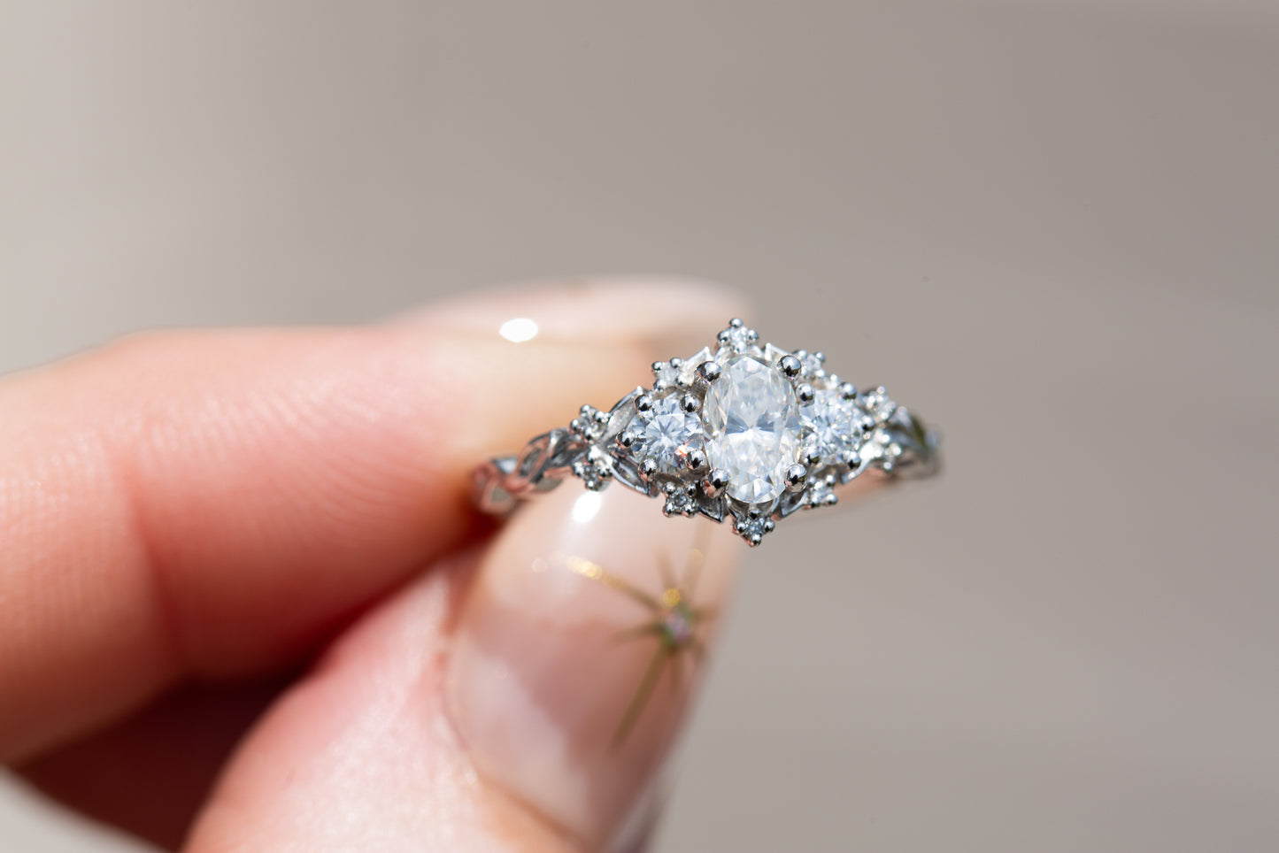 Briar rose three stone with oval moissanite center and round moissanite sides