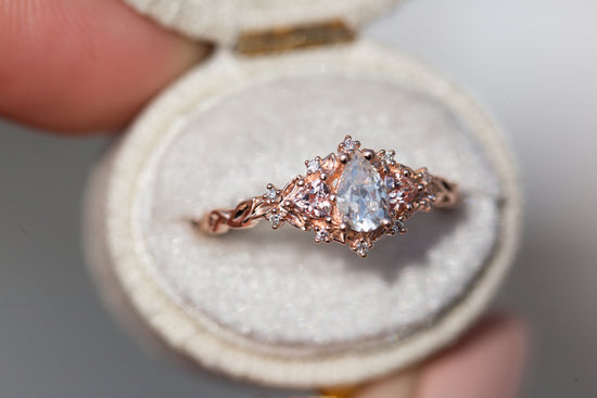 Briar rose three stone with pear moissanite and peach sapphire side stones