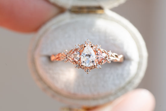 Briar rose three stone with pear moissanite and peach sapphire side stones