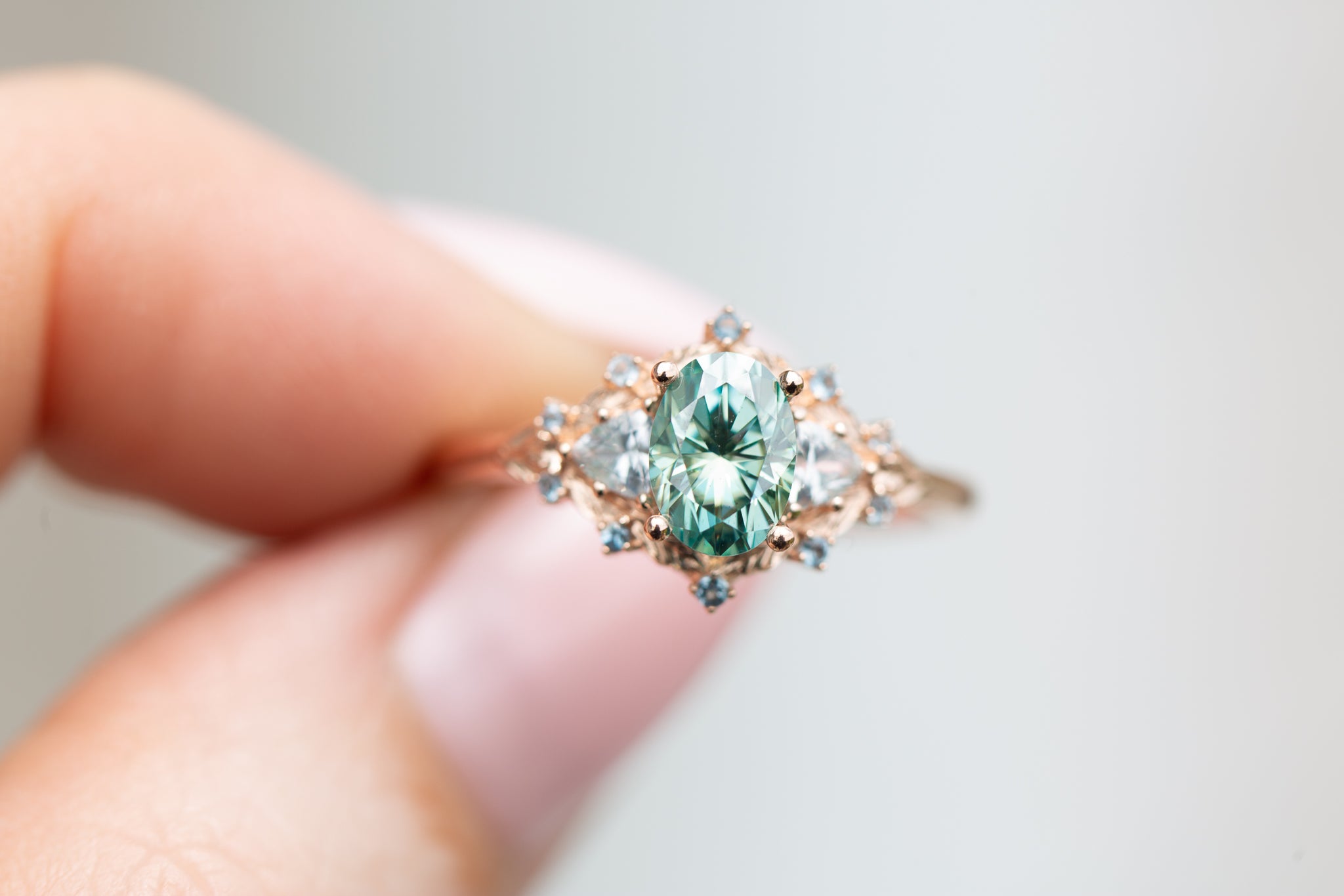 Woodland three stone with teal moissanite and aqua accents