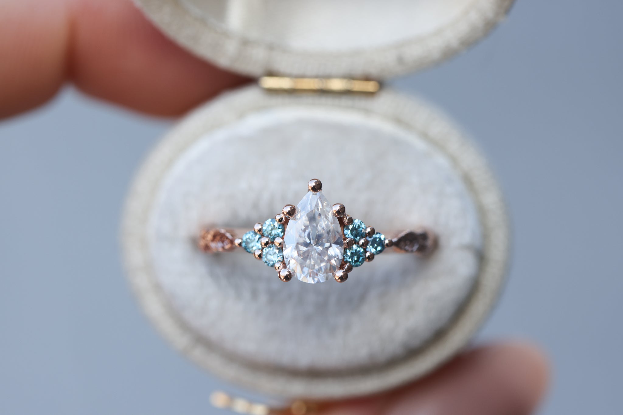 Seraphina with pear moissanite center and aqua irradiated diamonds