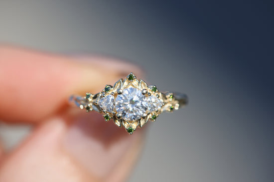 Briar rose three stone with 5.5mm round moissanite and green diamonds accents