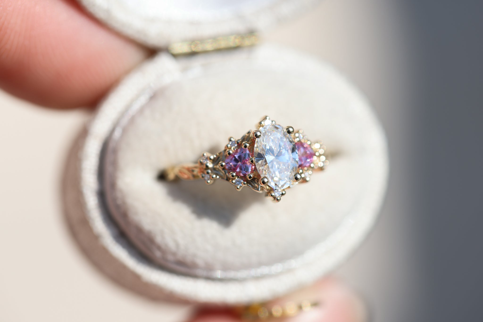 Briar rose three stone with oval lab diamond center and lab pink