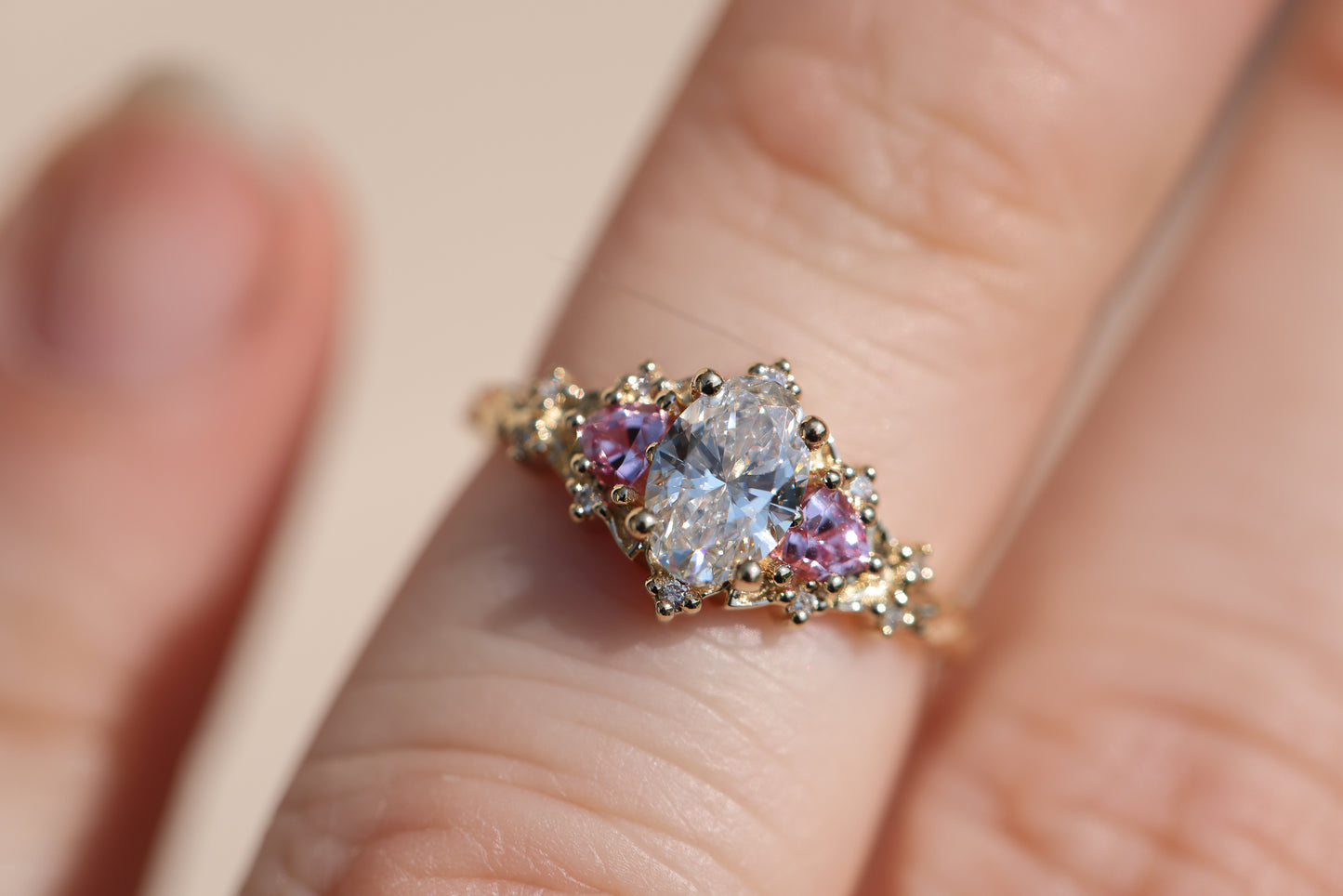 Load image into Gallery viewer, Briar rose three stone with oval lab diamond center and lab pink sapphire sides
