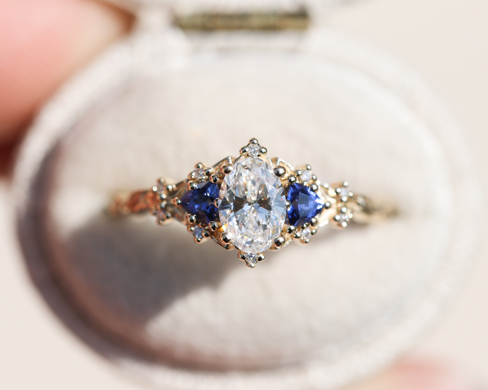 Briar Rose Three Stone with oval lab diamond center and lab blue
