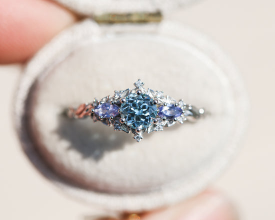 Briar rose three stone with round aquamarine center and marquise tanzanite sides