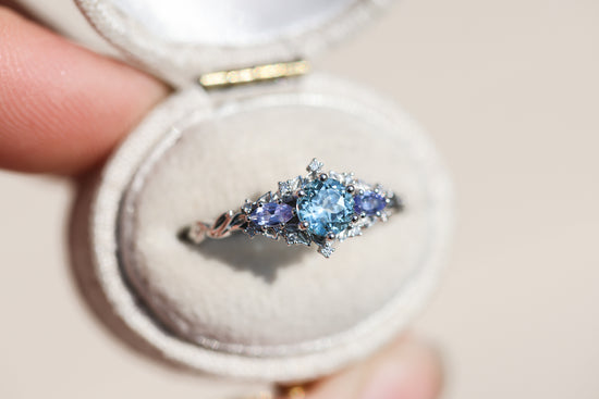 Briar rose three stone with round aquamarine center and marquise tanzanite sides