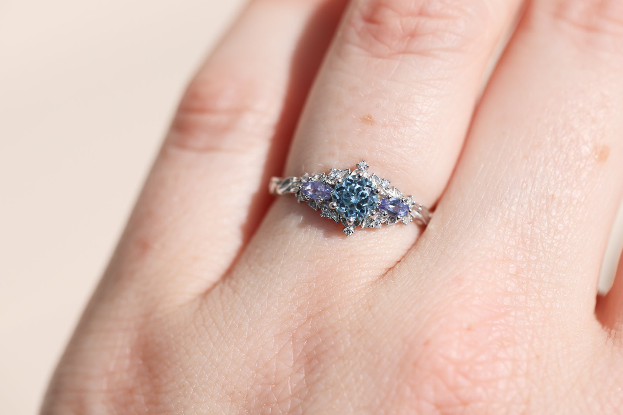 Briar rose three stone with round aquamarine center and