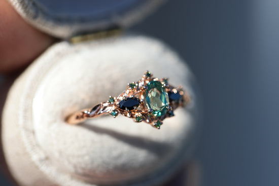 Load image into Gallery viewer, Briar rose three stone with lab green sapphire and black/green diamond sides
