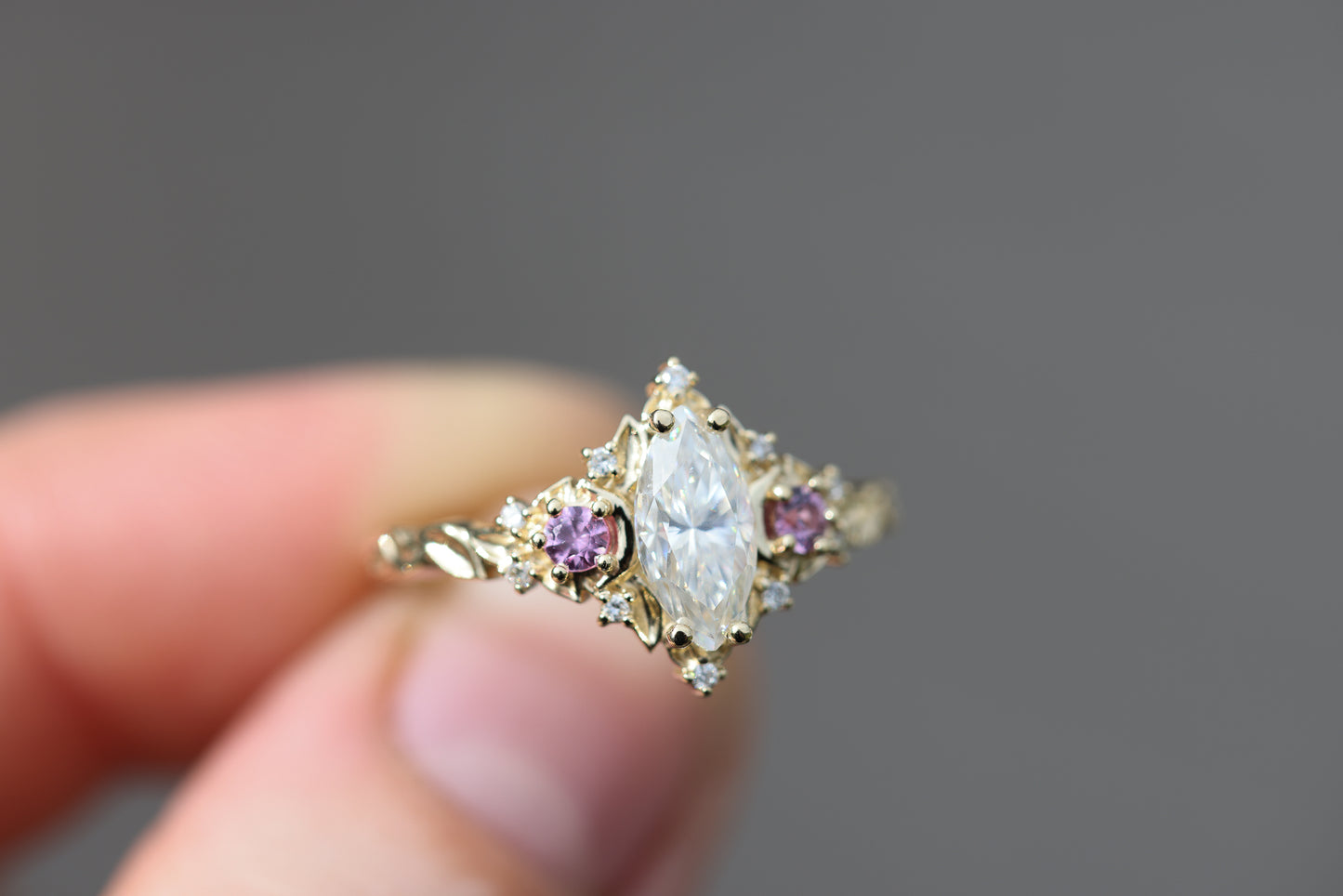 Briar moon three stone with marquise moissanite and round pink sapphire side stones