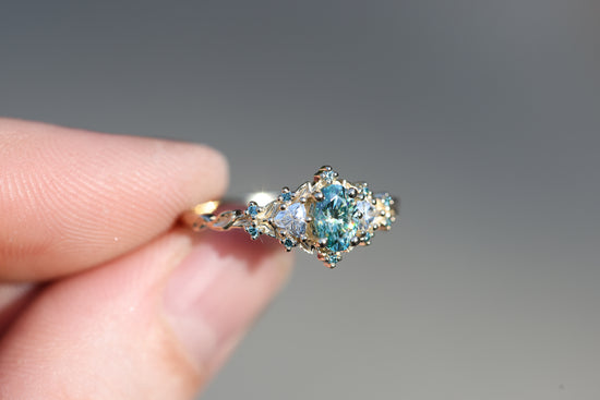 Briar rose three stone with oval teal moissanite and aqua diamonds