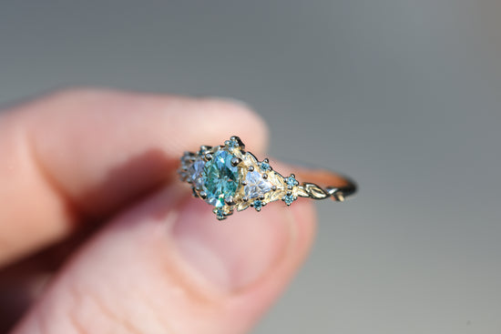 Briar rose three stone with oval teal moissanite and aqua diamonds