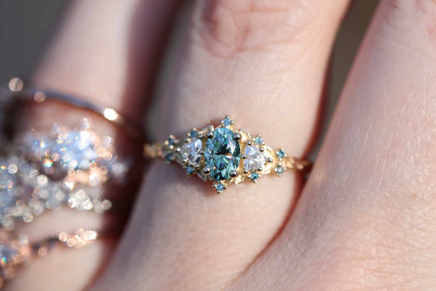 Briar rose three stone with oval teal moissanite and aqua diamonds