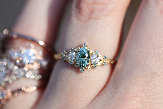 Briar rose three stone with oval teal moissanite and aqua diamonds