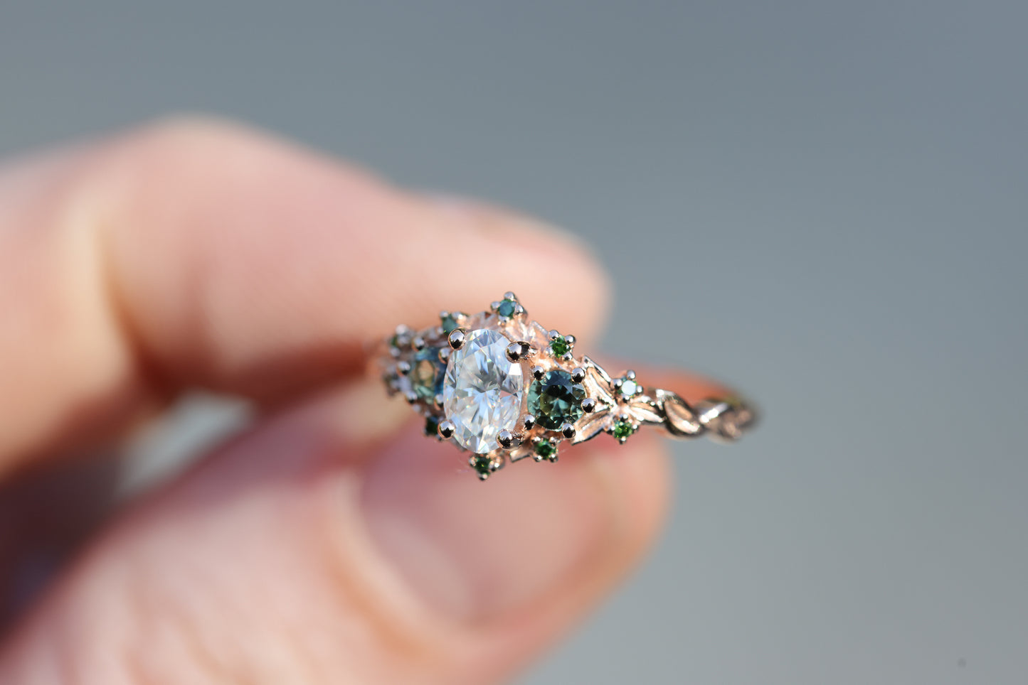 Briar three with oval moissanite and natural teal green sapphire