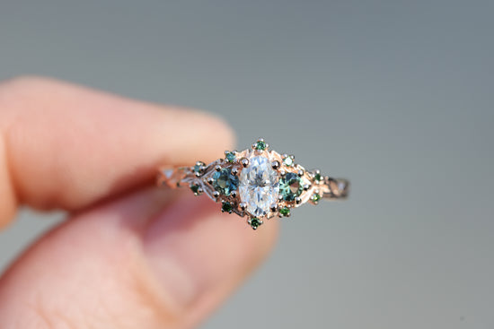 Briar three with oval moissanite and natural teal green sapphire