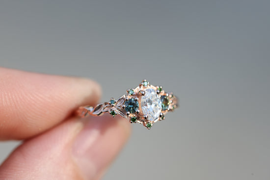 Briar three with oval moissanite and natural teal green sapphire