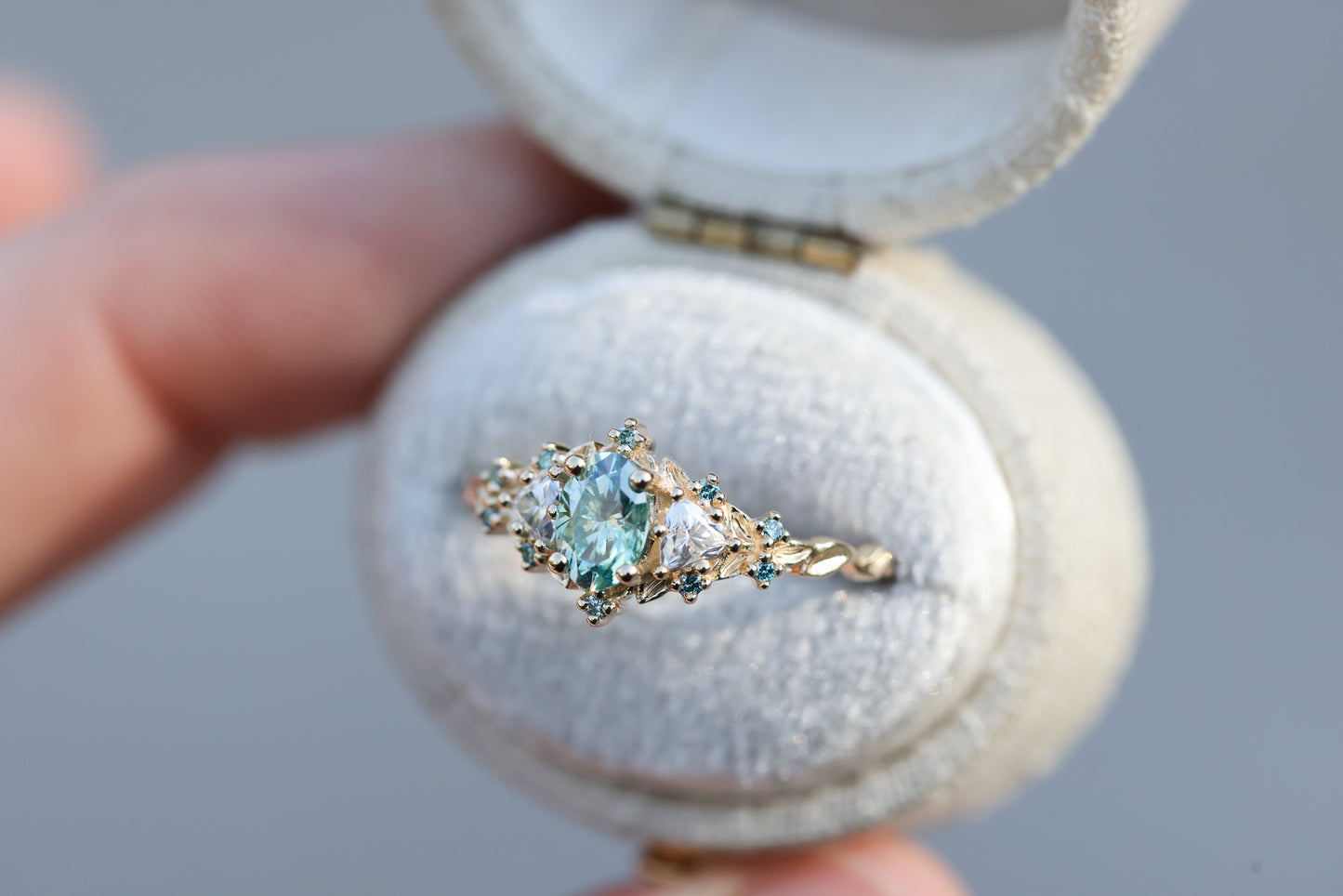 Briar rose three stone with oval teal moissanite and aqua diamonds