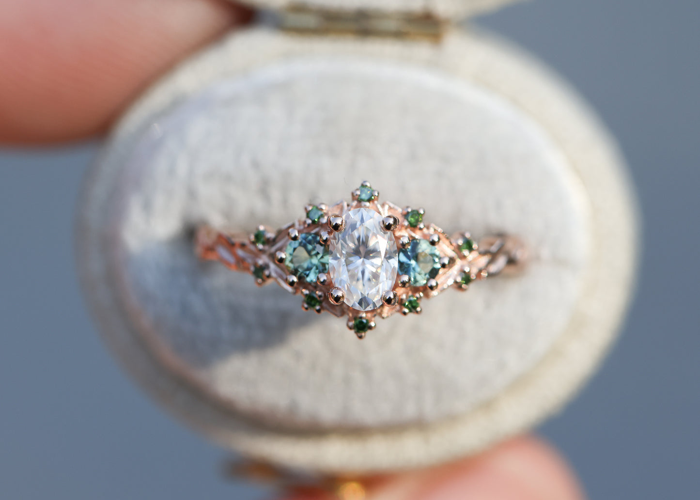 Briar three with oval moissanite and natural teal green sapphire