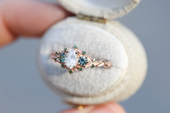 Briar three with oval moissanite and natural teal green sapphire