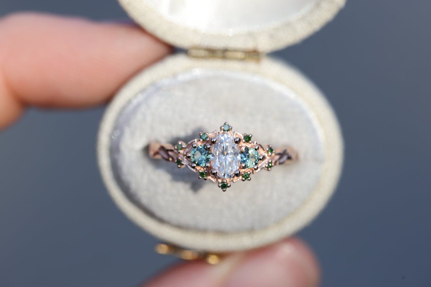 Briar three with oval moissanite and natural teal green sapphire