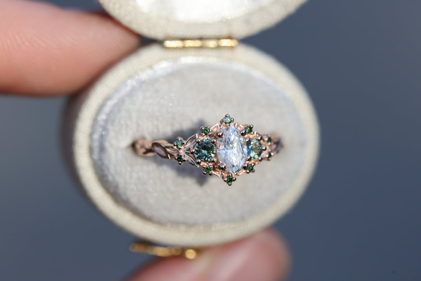 Briar three with oval moissanite and natural teal green sapphire