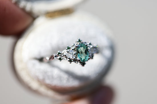 Briar rose three stone with oval lab green sapphire and green diamond accents